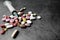 Syringe and pills on dark background, close up