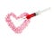 Syringe and pink pills form heart shape