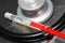 Syringe and stethoscope on a metal surface