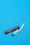 Syringe, test tubes with blood samples and ampoules with medicines or vaccine over blue background