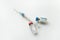 syringe and two vials of vaccine on a white background. The concept of vaccination and treatment of viruses and diseases