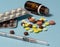 Syringe and various medications, vitamins pills laid out on a background