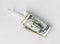 Syringe is wrapped in a hundred-dollar bill, the concept of addiction and addiction, the high cost of medical vaccines, a flat lay