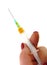 syringe with a yellow medicine in women\'s hands,