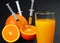 Syringes injected into orange and juice