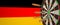 Syringes with a vaccine hit target near the German flag. Successful research and vaccination in Germany. Conceptual 3D