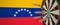 Syringes with a vaccine hit target near the Venezuelan flag. Successful medical research and vaccination in Venezuela