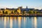 Szczecin. Night view from across the river to the illuminated historic center. Odra river. Chrobry embankments in Szczecin