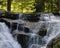 Szklarka Falls in super green forest surroundings, Karkonoski National Park, Poland