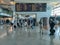 Sá Carneiro airport interior view, departures and arrivals information board, people walking with suitcases and bags and staying