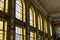 SÃ£o bento railway station windows. Warm light passing through the tall windows, while two pigeons are perched in one of them.