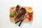 T-bone beef stake served on a cutting board