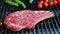 T bone beef steak on grill grate, flame. Raw meat steak on grill zoom in. Close up.