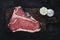 T-bone Steak Raw Dry Aged Beef on Vintage Cutting Board