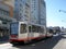 T Muni Light-rail train with ad on side on 4th street in Mission Bay