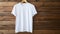 T-shirt mockup on wood background. White tshirt mock-up. Blank template Tee mock up near wooden wall. Male casual urban clothes.