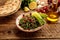 TABBOULEH with bread and lime served in a dish isolated on grey background side view