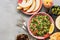 Tabbouleh or Parsley salad on pink platter, easy and healthy classic vegetarian dish with bulgur, tomatoes, parsley, spring onion