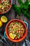 Tabbouleh salad - bulgur groats, tomatoes, cucumber, parsley, lemon, onion and fresh mint leaves on wooden background