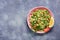 Tabbouleh salad, plate, rustic blue background.Traditional Lebanese dish. Middle Eastern diet food. Top view, copy space.