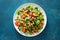 Tabbouleh salad. Tabouli salad with fresh parsley, onions, tomatoes, bulgur and chickpea. Healthy vegetarian food, diet. Top view