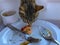 Tabby cat tasting and stealing sweet cake dessert from food tray