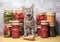 Tabby kitten yawns near glass jars of pickled vegetables. Ð¡oncept of home canning vegetables for the winter