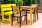 Table and armchairs on outdoor terrace of summer cafe