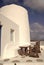 Table and bench in yard of Mykonos, Greece. House on mountain landscape, architecture. Building with whitewashed walls