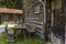 Table and benches in front of an old traditional wood chalet on the alpine meadows in Switzerland during spring