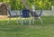 Table and blue four chair in the garden with green lawn grass