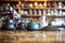 table with blurred shelves of coffee beans and teapots