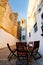 Table and chairs in alley