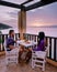 Table and chairs with breakfast during sunrise at the meditarian sea in Greece