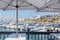 Table and chairs at a restaurant in Club Mykonos, harbour with yatchts and accommodation in background