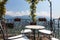 Table and chairs on a terrace overlooking lake and mountains in