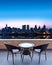 Table and chairs on a terrace, view on a city