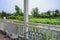 Table and chairs in veranda of lakeside wooden cabin at sunny summer nooon