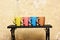 Table with colourful cups on wall background.
