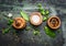 Table or cooking seasoning in wooden bowls on rustic background