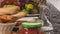 Table with decanter, baguette, fried chiken, salami and fruits