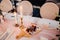 Table decorated with plates with beads and candles on a white tablecloth and cherries and cheese on a cutting board.