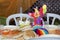 Table decoration on the Purim holiday - clown, pitta bread and two white plastic chairs