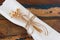 Table decoration serviette with dried flowers on wooden table