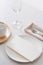 Table decoration. White plates, fork, knife on grey stone plate