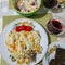 A table with dishes: pilaf, a glass of wine and other