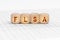 On the table with documents are wooden cubes with the inscription - FLSA