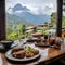 A table with elegantly arranged dishes against a background of mountain ranges visible outside the window