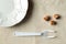 On the table, empty white plate and lying next to the crackers. A fork with broken middle teeth symbolizes voluntary dietary