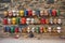 table filled with vibrantly painted masks against a stone wall